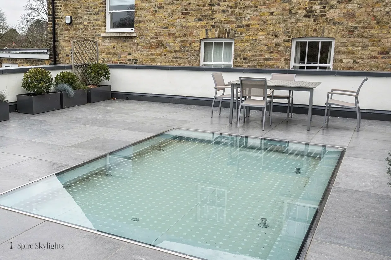 Walk-on rooflight set flush into a paved roof terrace