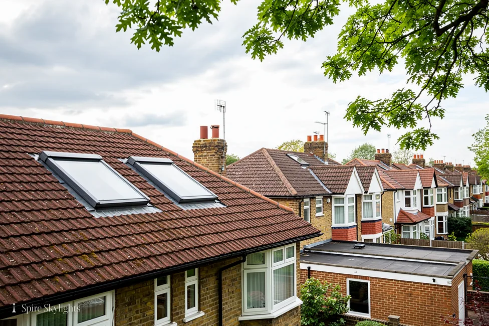 Roof windows in the tiled roof of a semi-detached house