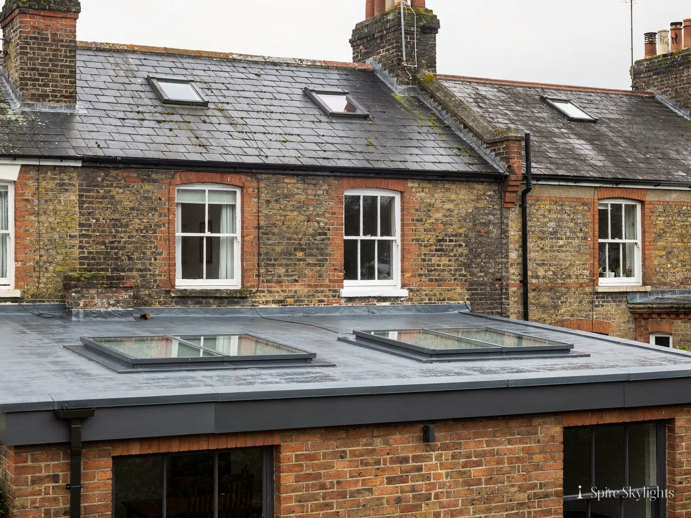 Two flat rooflights on the single-storey extension of a brick terrace