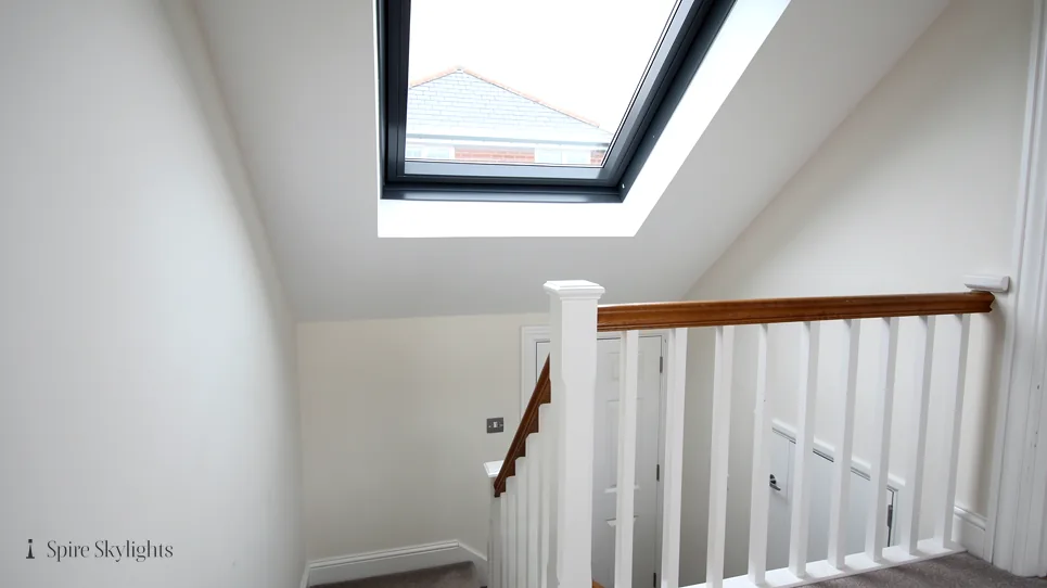 Roof window above a stairwell with white spindles