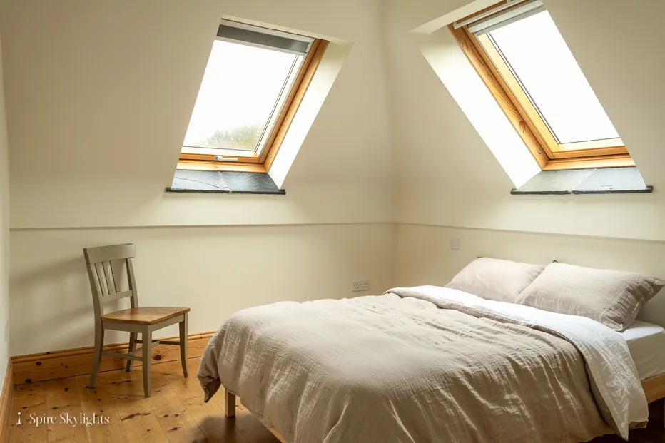 Two pine roof windows over a loft bedroom