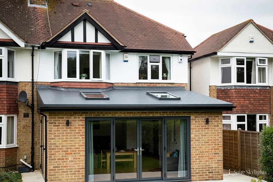 Mock-Tudor semi with a flat-roof rear extension, three rooflights and folding doors
