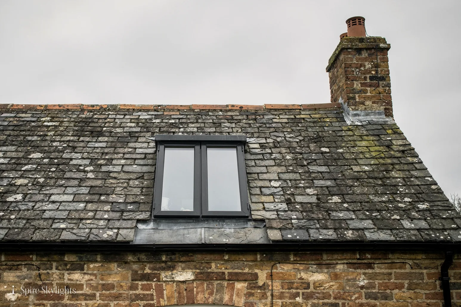 Twin conservation-style rooflight in an old slate roof