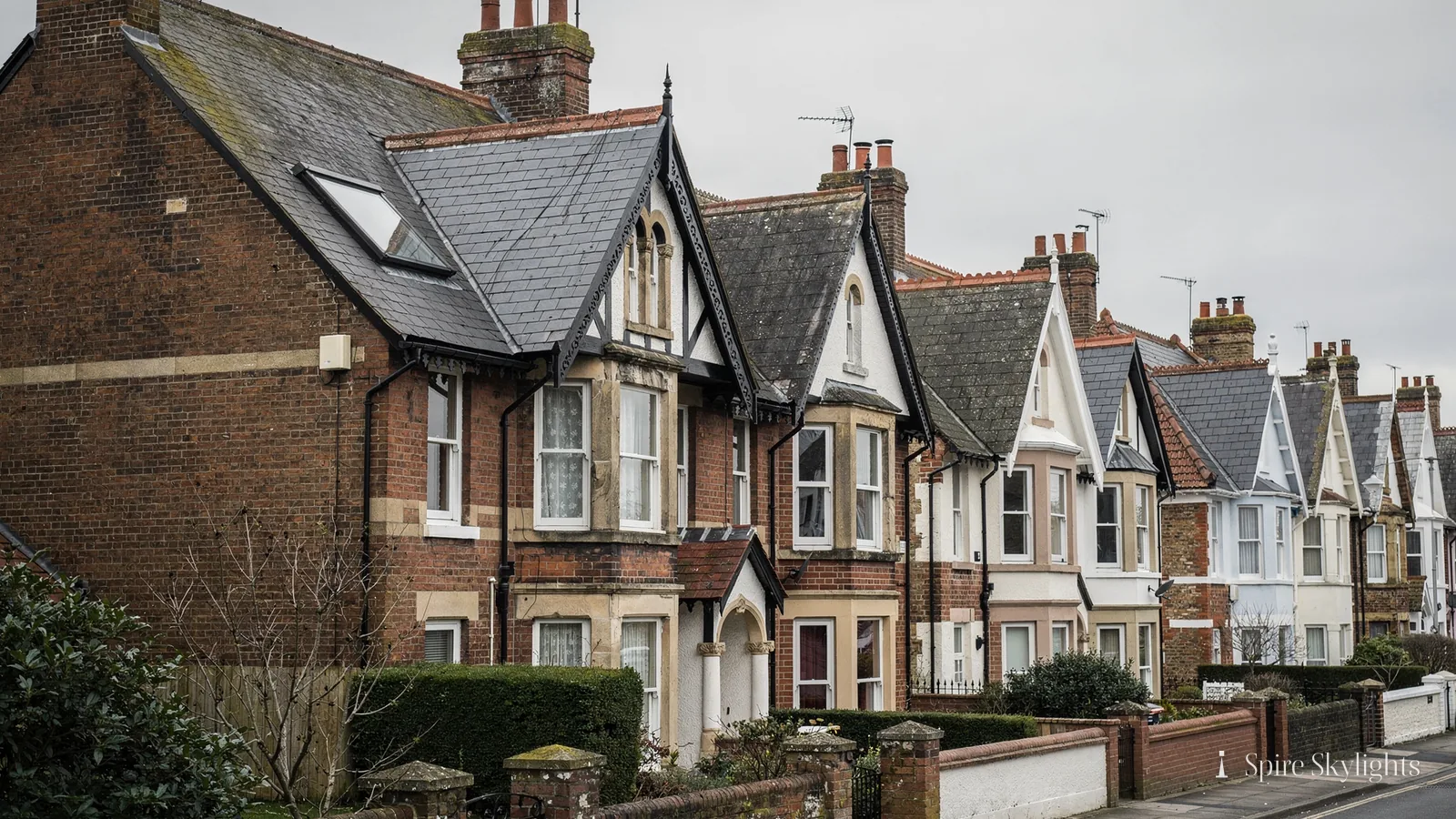 Street of Edwardian semis with roof windows in the slate roofs